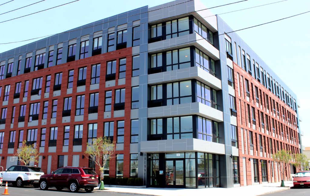 A red and white building with cars parked in front of it.